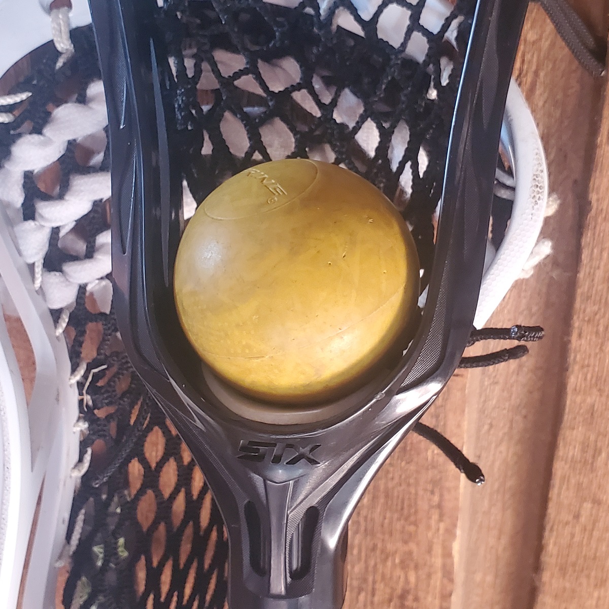 photo-of-a-greaser-lacrosse-ball-in-a-girls-lacrosse-stick